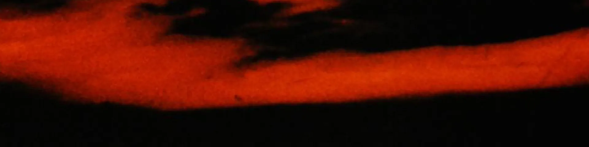 Red brush across black background
