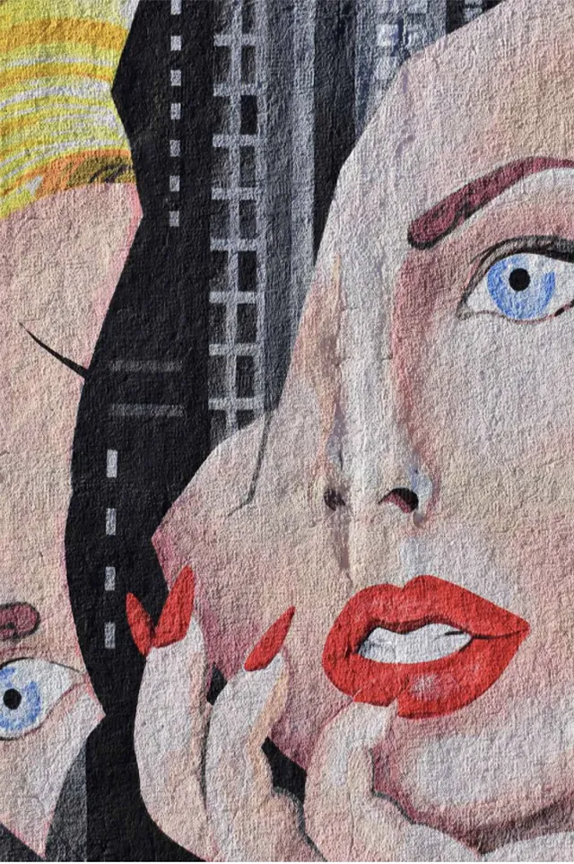 painted woman's broken face on the the background of a skyline