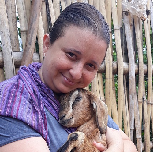 Mara Green, headshot holding baby goat